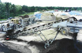 On-site soil remediation. This particular job required additional material to be crushed on-site and blended through the pugmill in order to meet government specifications.